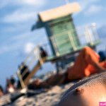 Woman sunbathing topless Miami
